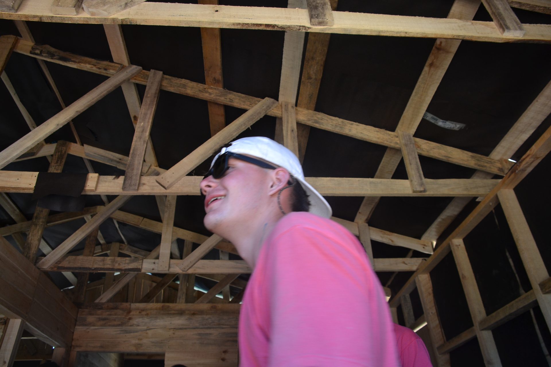 Voluntario sonriente en el interior de la estructura de madera